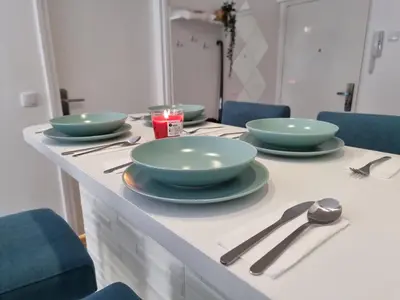 a table with four bowls and spoons on it at The Blue Velvet Apartment in Belgrade
