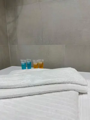 a bed with two cups and two bottles on it at The Blue Velvet Apartment in Belgrade