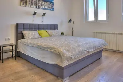 a bedroom with a large bed with yellow pillows at Kalemegdan Central Apartment in Belgrade