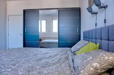 a bedroom with a bed and a large mirror at Kalemegdan Central Apartment in Belgrade