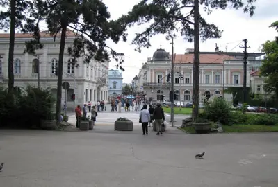 a group of people walking in a plaza in front of a building at Kalemegdan Central Apartment in Belgrade