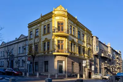 a yellow building on the corner of a street at Kalemegdan Central Apartment in Belgrade