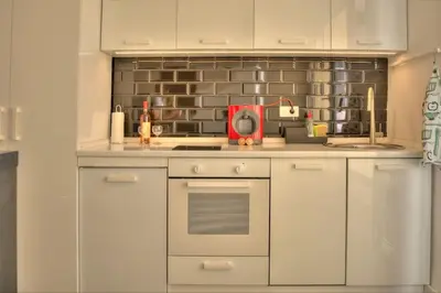 a kitchen with white cabinets and a counter top at Kalemegdan Central Apartment in Belgrade