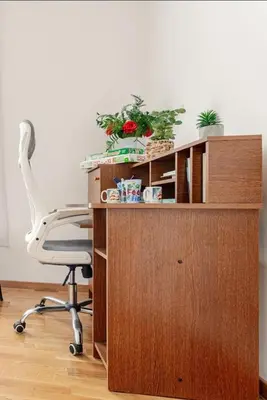 a desk with a white chair and a wooden cabinet at Penthouse Danube Exclusive, Parking, 90m2, Wifi in Novi Grad