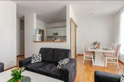 a living room with a black couch and a table at Penthouse Danube Exclusive, Parking, 90m2, Wifi in Novi Grad