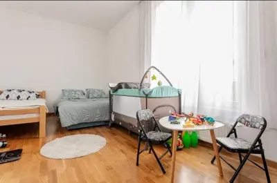 a room with a bed and a table and chairs at Penthouse Danube Exclusive, Parking, 90m2, Wifi in Novi Grad
