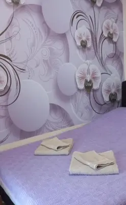 a purple bedroom with two towels on a bed at Libero 78 in Vračar (historical)