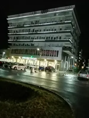 a large building on a city street at night at Apartman Dana in Nova Pazova