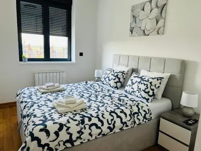 a bedroom with a bed with two towels on it at Oasis in Jajinci