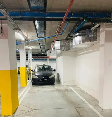 a car parked inside of a parking garage at Oasis in Jajinci