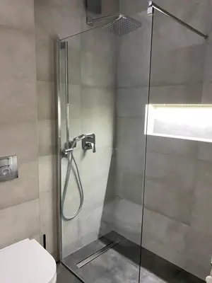 a shower with a glass door in a bathroom at Oasis in Jajinci