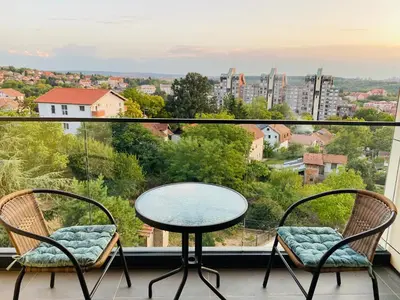 a balcony with a table and chairs and a view at Oasis in Jajinci