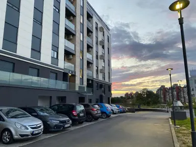 a row of cars parked in front of a building at Oasis in Jajinci