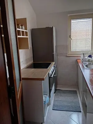 a small kitchen with a sink and a refrigerator at Stan u samom centru Obrenovca, na Trgu 2 in Obrenovac
