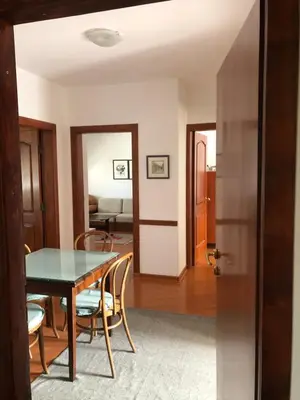 a dining room and living room with a table and chairs at Stan u samom centru Obrenovca, na Trgu 2 in Obrenovac