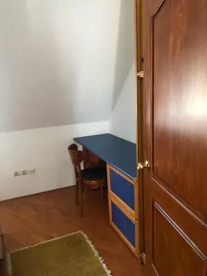 a room with a blue desk and a wooden door at Stan u samom centru Obrenovca, na Trgu 2 in Obrenovac