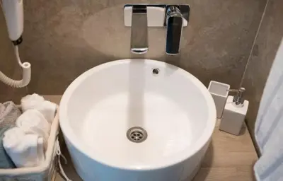 a white sink in a bathroom with towels at The Empress apartment Belgrade in Belgrade