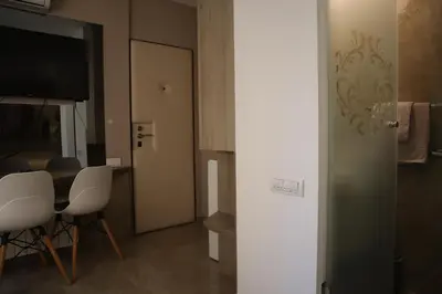 a room with a table and chairs and a television at The Empress apartment Belgrade in Belgrade