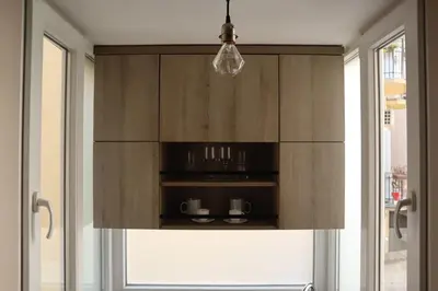 a kitchen with wooden cabinets and a window at The Empress apartment Belgrade in Belgrade