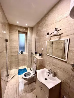 a bathroom with a toilet and a sink and a shower at Hugolina LUX in Belgrade