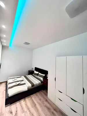 a bedroom with a bed and a blue ceiling at Hugolina LUX in Belgrade