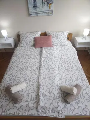 a bed with two pairs of socks and shoes on it at Cezar in Arandjelovac