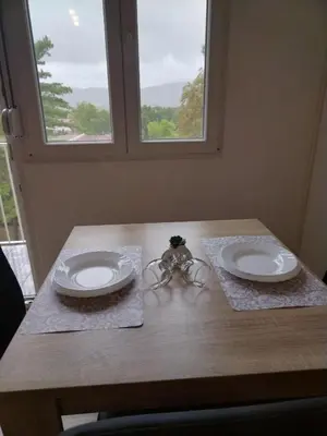 a wooden table with two plates on top of it at Cezar in Arandjelovac