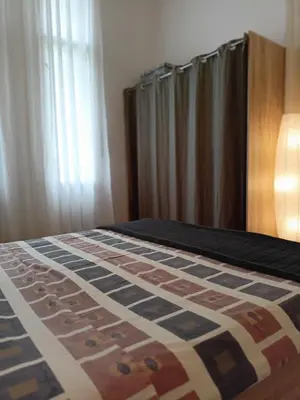 a bed with a quilt on it in a bedroom at Evergreen in Belgrade