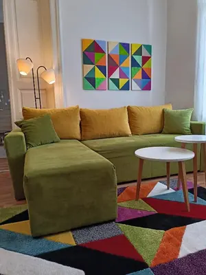 a living room with a green couch and two tables at Evergreen in Belgrade