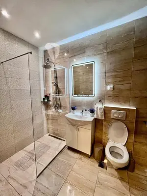 a bathroom with a toilet and a sink and a shower at Hugo Bianca LUX in Belgrade