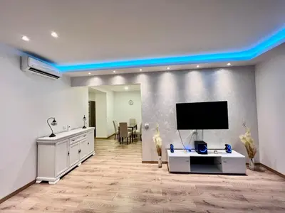 a living room with a flat screen tv on a wall at Hugo Bianca LUX in Belgrade