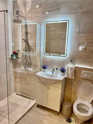 a bathroom with a toilet and a sink and a shower at Hugo Bianca LUX in Belgrade