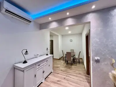 a kitchen and dining room with a blue ceiling at Hugo Bianca LUX in Belgrade