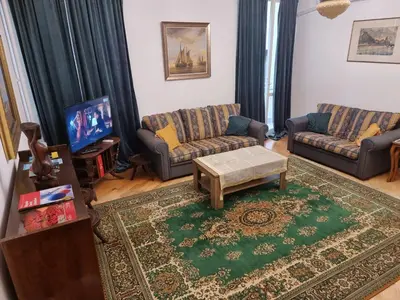 a living room with two couches and a tv at Big Downtown Apartment across National Theater (2 Bedrooms) in Belgrade