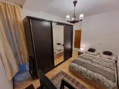 a bedroom with two beds and a mirror at Big Downtown Apartment across National Theater (2 Bedrooms) in Belgrade