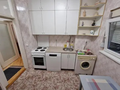 a small kitchen with a stove and a sink at Big Downtown Apartment across National Theater (2 Bedrooms) in Belgrade