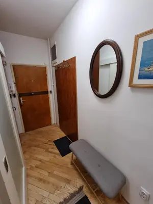 a room with a mirror on the wall and a bench at Big Downtown Apartment across National Theater (2 Bedrooms) in Belgrade