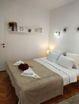a hotel room with two beds with flowers on it at Palace Luxury Apartments The Heart of Belgrade in Belgrade