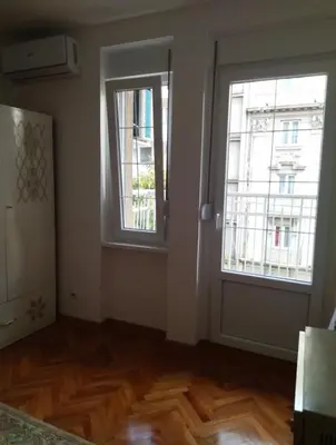 a room with two windows and a wooden floor at Palace Luxury Apartments The Heart of Belgrade in Belgrade