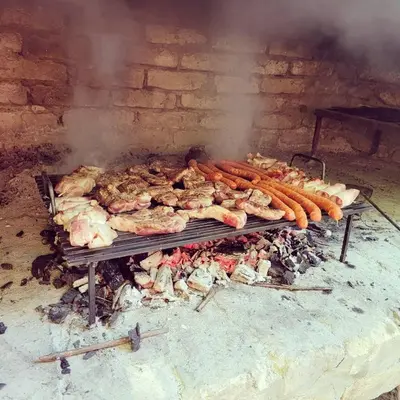 a bunch of chickens and chickens cooking on a grill at Rent a Forest, Cabin Hidden in the Fruška gora in Velika Remeta