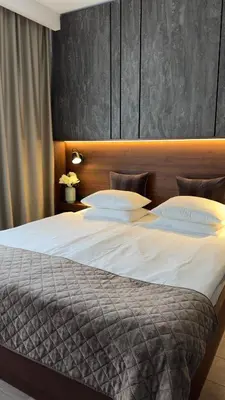 a large bed with white sheets and pillows at DOM Boutique Apartments OLD TOWN in Belgrade