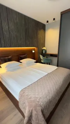 a bedroom with a large bed with a large white comforter at DOM Boutique Apartments OLD TOWN in Belgrade