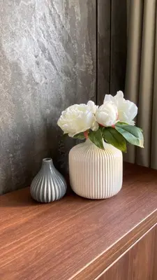 two white vases sitting on a wooden shelf with flowers at DOM Boutique Apartments OLD TOWN in Belgrade