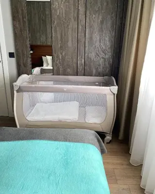 a bathroom with a mirror and a bed with towels at DOM Boutique Apartments OLD TOWN in Belgrade