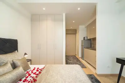 a bedroom with a bed with a red pillow on it at BW Aurora 108 in Belgrade