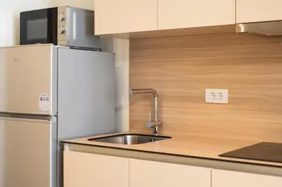 a kitchen with a sink and a refrigerator at BW Aurora 108 in Belgrade