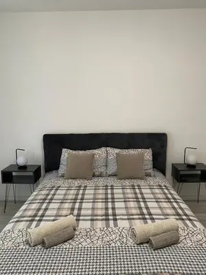 a bedroom with a bed with two pillows on it at Grand Royal in Belgrade