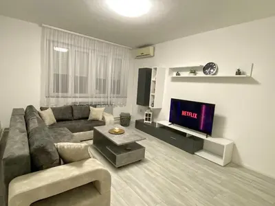 a living room with a couch and a tv at Grand Royal in Belgrade