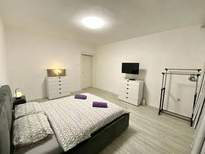 a bedroom with a bed with purple pillows on it at Grand Royal in Belgrade
