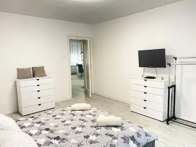 a bedroom with a bed and a flat screen tv at Grand Royal in Belgrade